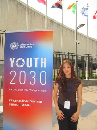 Vivian Liu at the UN Youth 2030 banner outside UN Headquarters
