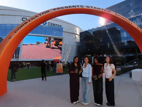 Vivian Liu and friends at the Y Combinator Startup School 2026 entrance arch outside the Chase Center in San Francisco