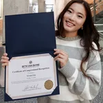 Vivian holding her Certificate of Congressional Recognition from Congresswoman Beth Van Duyne