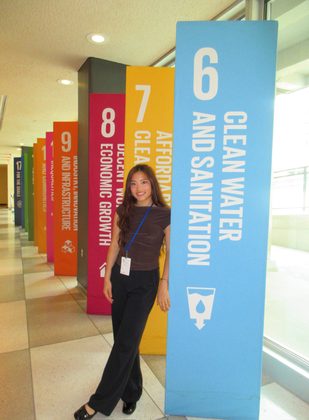 Vivian Liu with the Sustainable Development Goals display at UN Headquarters