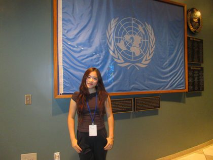 Vivian Liu with the UN flag at United Nations Headquarters